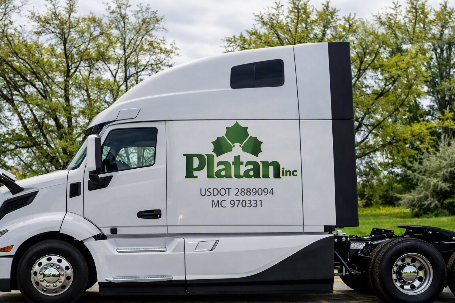 Platan Inc tractor cab parked in front of trees